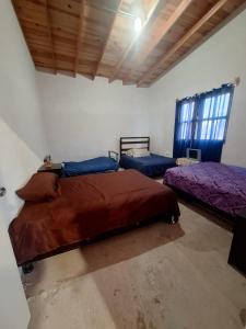 a room with two beds in a room at Cabaña Marmolejo in Arteaga