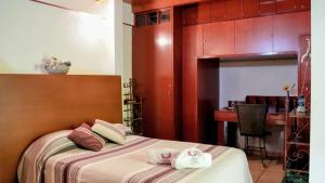 a bedroom with a bed with towels on it at Suites CDMX in Mexico City