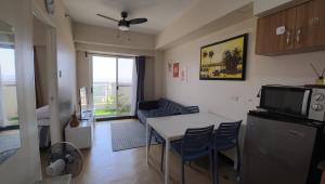 a kitchen and living room with a table and chairs at Manila Sunset View in Manila +12 photos