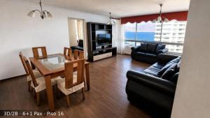 a living room with a dining table and a television at Departamentos Nautilus in Iquique