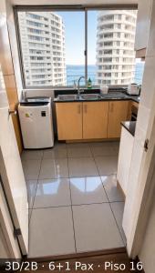 a kitchen with a sink and a window at Departamentos Nautilus in Iquique