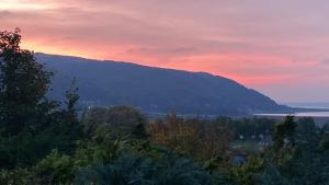 a view of a mountain with a sunset in the background at Bay View Porlock Bed & Breakfast in Porlock
