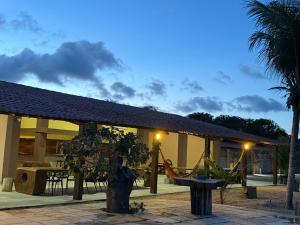 a building with a statue in front of it at Hotel Fazenda Alta Vista in Fortim