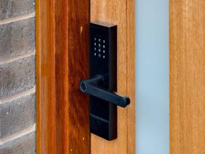 a black door handle on a wooden door at Central Studio in new townhouse in Beechworth +2 photos