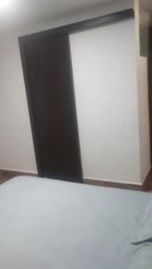 a mirror in a room with a white wall at Suites Clarinda in Capitólio
