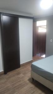 a bedroom with a bed and a sliding door at Suites Clarinda in Capitólio +55 photos