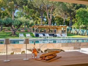 a table with bread on it next to a swimming pool at Vue Saint Tropez in Grimaud