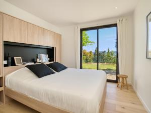 a bedroom with a large bed and a large window at Vue Saint Tropez in Grimaud +37 photos