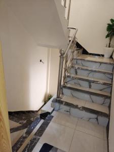 a staircase in a room with a tiled floor at Khouribga in Khouribga +2 photos