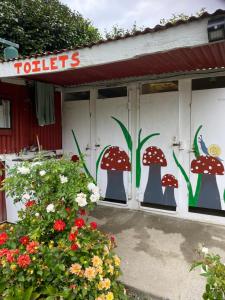 a store front with mushrooms painted on the windows at Waitomo Farmstay - Kiwi Cabin 5 in Waitomo Caves