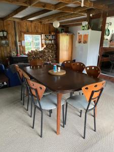 a dining room table and chairs in a room at Waitomo Farmstay - Kiwi Cabin 5 in Waitomo Caves