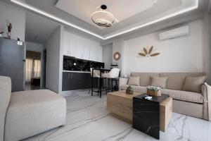 a living room with a couch and a table at Candi Luxury Suites 2 in Neos Marmaras