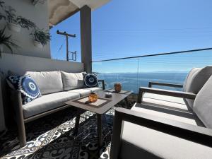 a living room with a couch and a table at Candi Luxury Suites 2 in Neos Marmaras