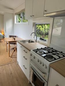 a kitchen with a stove and a sink at Tiny Escape in Lennox Head