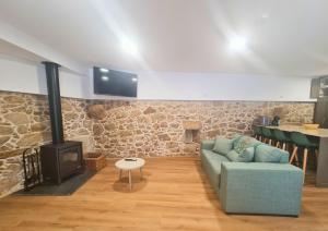 a living room with a couch and a wood stove at Quinta das Aromáticas in Malta