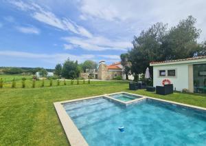 a swimming pool in the yard of a house at Quinta das Aromáticas in Malta