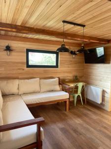 a room with a couch and a table in a room at Tiny Under Chalet in Santiago