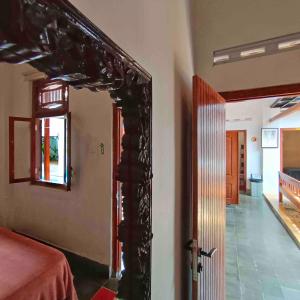an open door to a room with a bedroom at Sabi House Kates in Timuran