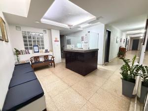 a hallway of a hospital with a counter and plants at Hotel Lords in Brasília