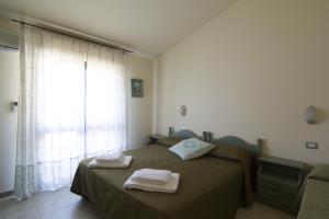 Postel nebo postele na pokoji v ubytování Agriturismo Sa Rocca