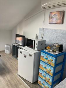 a kitchen with a refrigerator and a microwave at Cozy loft apartment in Pleven +4 photos