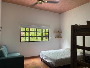 a bedroom with a bed and a window at Cabaña AWA in Puerto Salgar