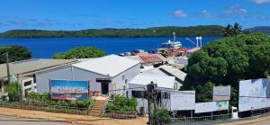 a view of a town with a boat in the water at Elim Hotel in Neiafu +21 photos