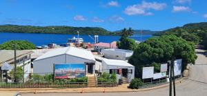 a building with a view of a body of water at Elim Hotel in Neiafu