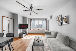 a living room with a couch and a table at Asahikawa Stay Ecole 101 in Asahikawa +47 photos