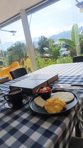 a table with a plate of food on a table at Refugio en la naturaleza in La Vega