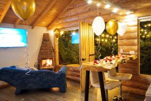a room with a table and balloons and a fireplace at Chalet el Pinar in La Calera