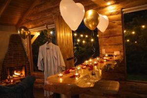 a room with a long table with candles and balloons at Chalet el Pinar in La Calera +26 photos
