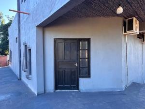 a black door on the side of a building at Colar in Oberá