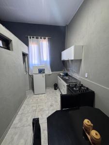 a small kitchen with a stove and a refrigerator at Colar in Oberá