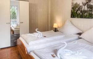 two beds in a hotel room with swans on them at Fh Blau in Warenthin