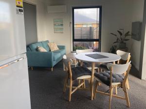a living room with a table and chairs and a couch at George Town Central Apartment in George Town +24 photos