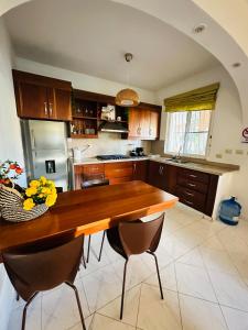 a kitchen with a wooden table and chairs at Villa del Sol #1 in La Laguna +8 photos