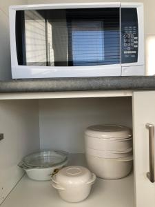 a microwave oven sitting on top of a kitchen counter at George Town Central Apartment in George Town