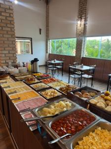 a buffet line with many different types of food at Pousada Alto do Sossego in Rio de Contas