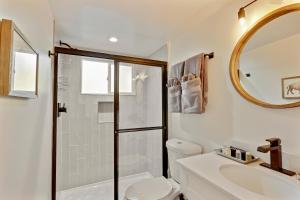 a bathroom with a shower and a toilet and a sink at Slopeside Chalet on River Next To WP Resort I Fantastic Views I Private Hot Tub I Gas Firepit I Game Room I Activity Program in Winter Park +29 photos