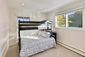 a black bunk bed in a room with a window at Slopeside Chalet on River Next To WP Resort I Fantastic Views I Private Hot Tub I Gas Firepit I Game Room I Activity Program in Winter Park