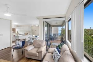 a living room with a couch and chairs at Sunset Reset in Soldiers Point +12 photos