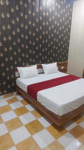 a bedroom with a bed with a red and white blanket at Hotel Vrindavan Near Prem Mandir Distance 15 min in Mathura +13 photos
