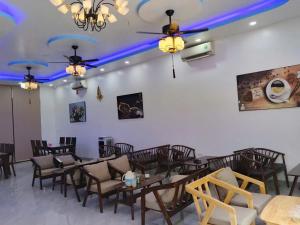 a dining room with tables and chairs and blue lights at Moonknight 2Hotel in Sầm Sơn +2 photos