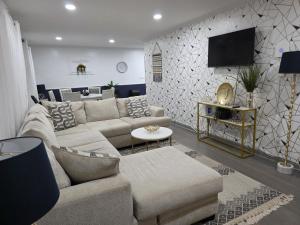 a living room with a couch and a tv at 3BR Home Best of Both-FIFA World Cup-Truist Park in Smyrna