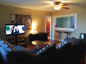 a living room with a couch and a flat screen tv at Downtown 1 Bedroom Apartment 18H in Atlanta