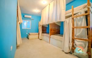 a room with two bunk beds and blue walls at Playa de la Fuente in El Paredón Buena Vista
