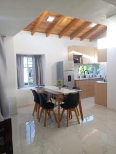 a kitchen with a wooden table and chairs at YulFran in Mina Clavero