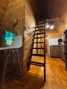a spiral staircase in a room with a kitchen at Cabañas The Twins in Medellín
