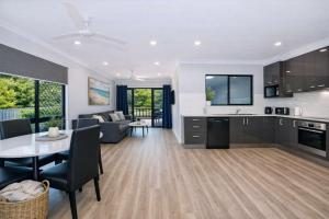 a kitchen and living room with a couch and a table at Golfside Haven 2 Bedroom Duplex with Golf Course in Rosslea